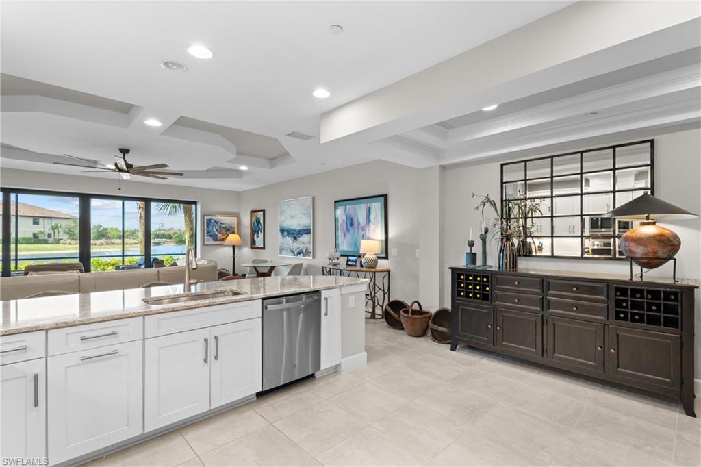 9646 Montelanico Loop, Unit 102 Naples, FL 34119 - Photo 10 of 42 a large white kitchen with a large window