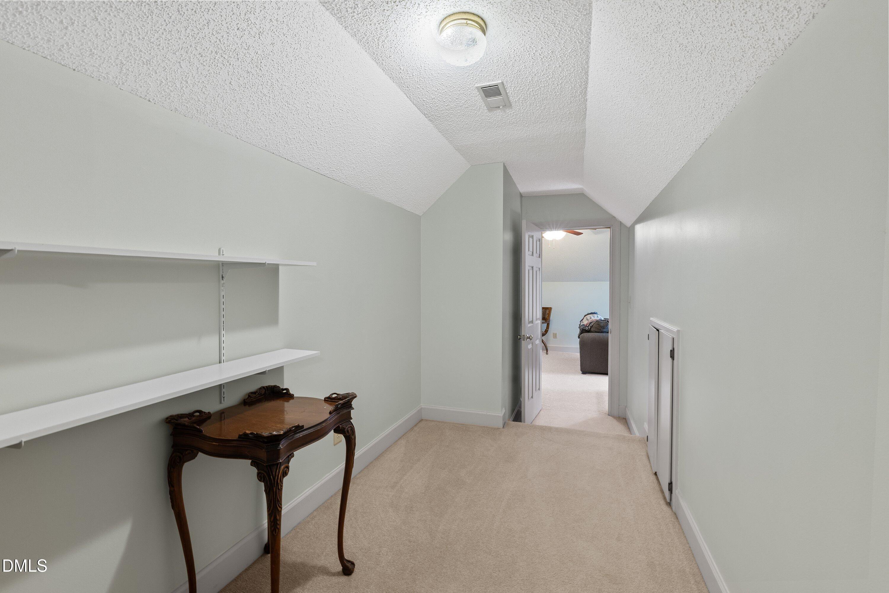 6314 Old Davis Road Sims, NC 27880 - Photo 47 of 71 a view of a hallway with a chair and frames on wall