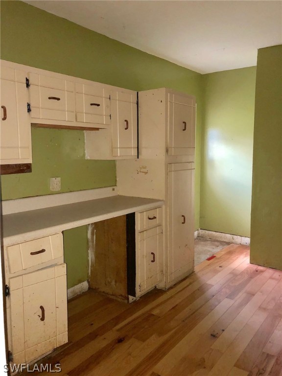 7206 Jasmine Road Fort Myers, FL 33967 - Photo 12 of 29 a kitchen with white cabinets and wooden floors