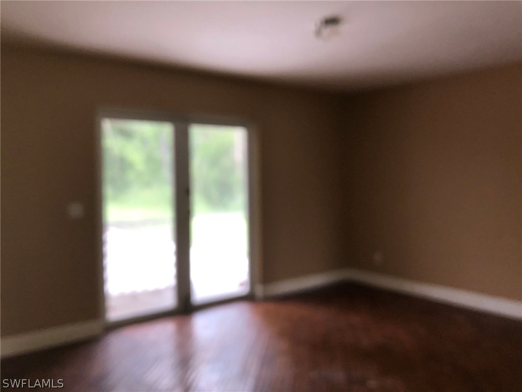 7206 Jasmine Road Fort Myers, FL 33967 - Photo 15 of 29 a view of empty room with wooden floor and fan