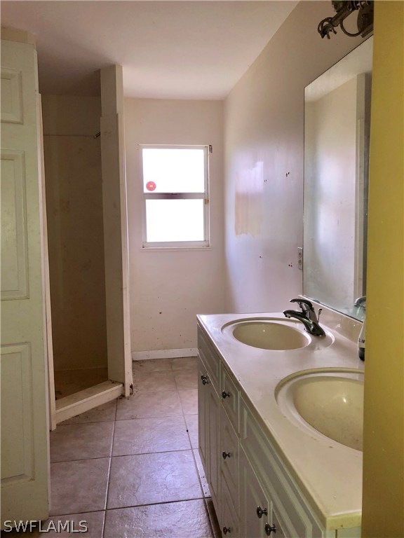 7206 Jasmine Road Fort Myers, FL 33967 - Photo 17 of 29 a bathroom with a granite countertop sink and a mirror