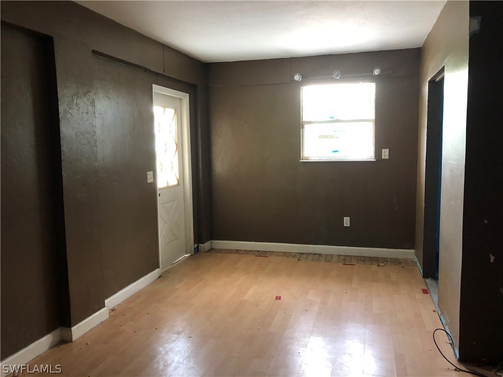 7206 Jasmine Road Fort Myers, FL 33967 - Photo 22 of 29 an empty room with wooden floor and windows