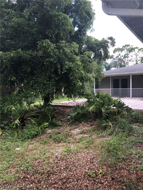 7206 Jasmine Road Fort Myers, FL 33967 - Photo 25 of 29 a view of a backyard with plants and a patio