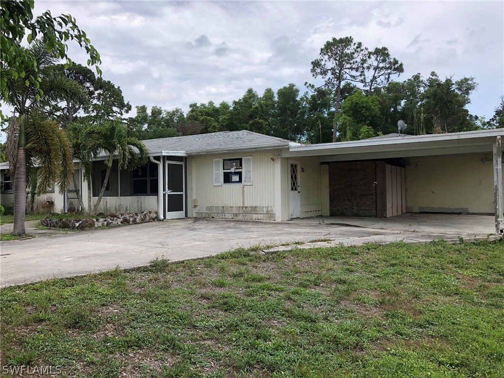 7206 Jasmine Road Fort Myers, FL 33967 - Photo 3 of 29 front view of a house with a yard