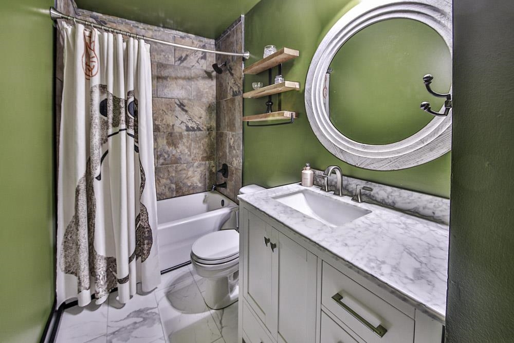 4736 Ridge Walk Lane Memphis, TN 38125 - Photo 18 of 23 Full bathroom featuring vanity, tile patterned floors, toilet, and shower / tub combo with curtain