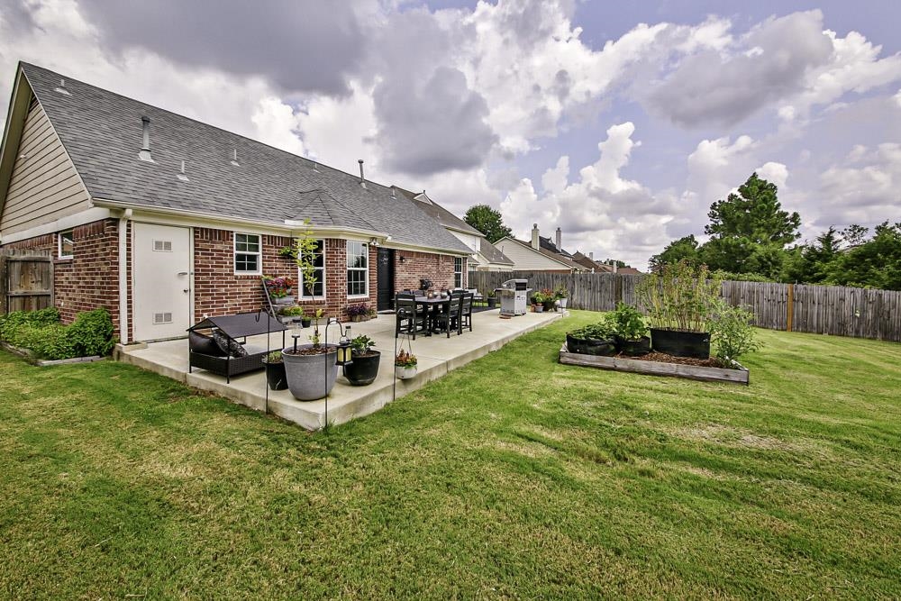 4736 Ridge Walk Lane Memphis, TN 38125 - Photo 20 of 23 Rear view of house with a patio and a lawn