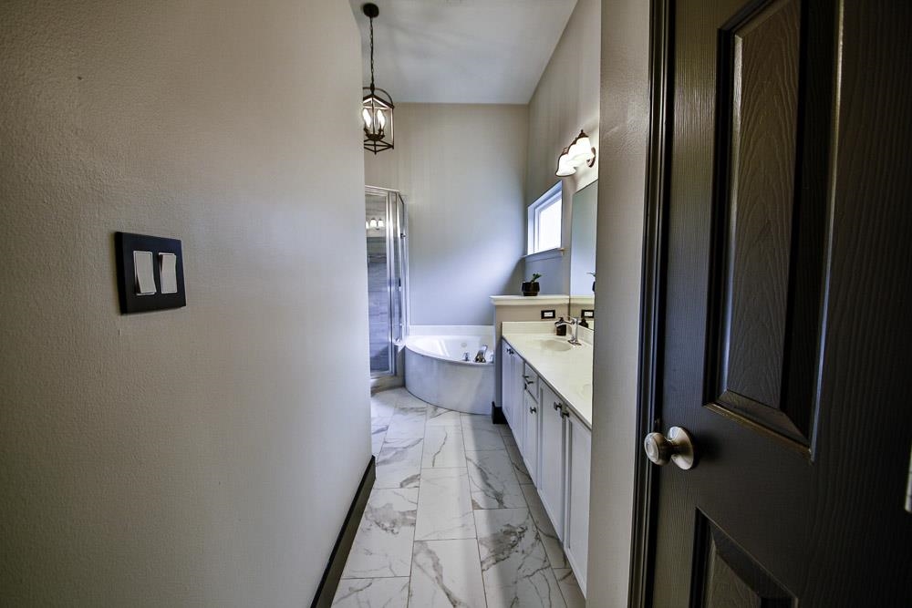 4736 Ridge Walk Lane Memphis, TN 38125 - Photo 7 of 23 Bathroom featuring vanity, a washtub, and tile patterned flooring