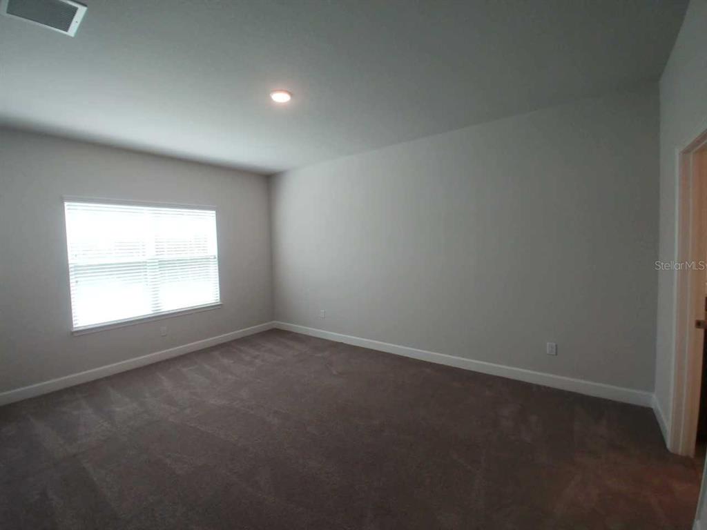 4380 Southwest 92nd Pl Road Ocala, FL 34476 - Photo 34 of 57 an empty room with a window