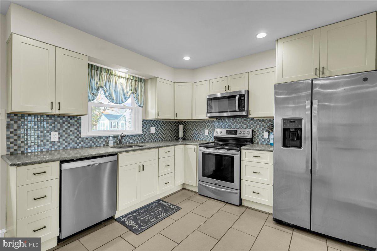 1909 Foulk Road Wilmington, DE 19810 - Photo 10 of 31 a kitchen with granite countertop a refrigerator stove top oven and sink