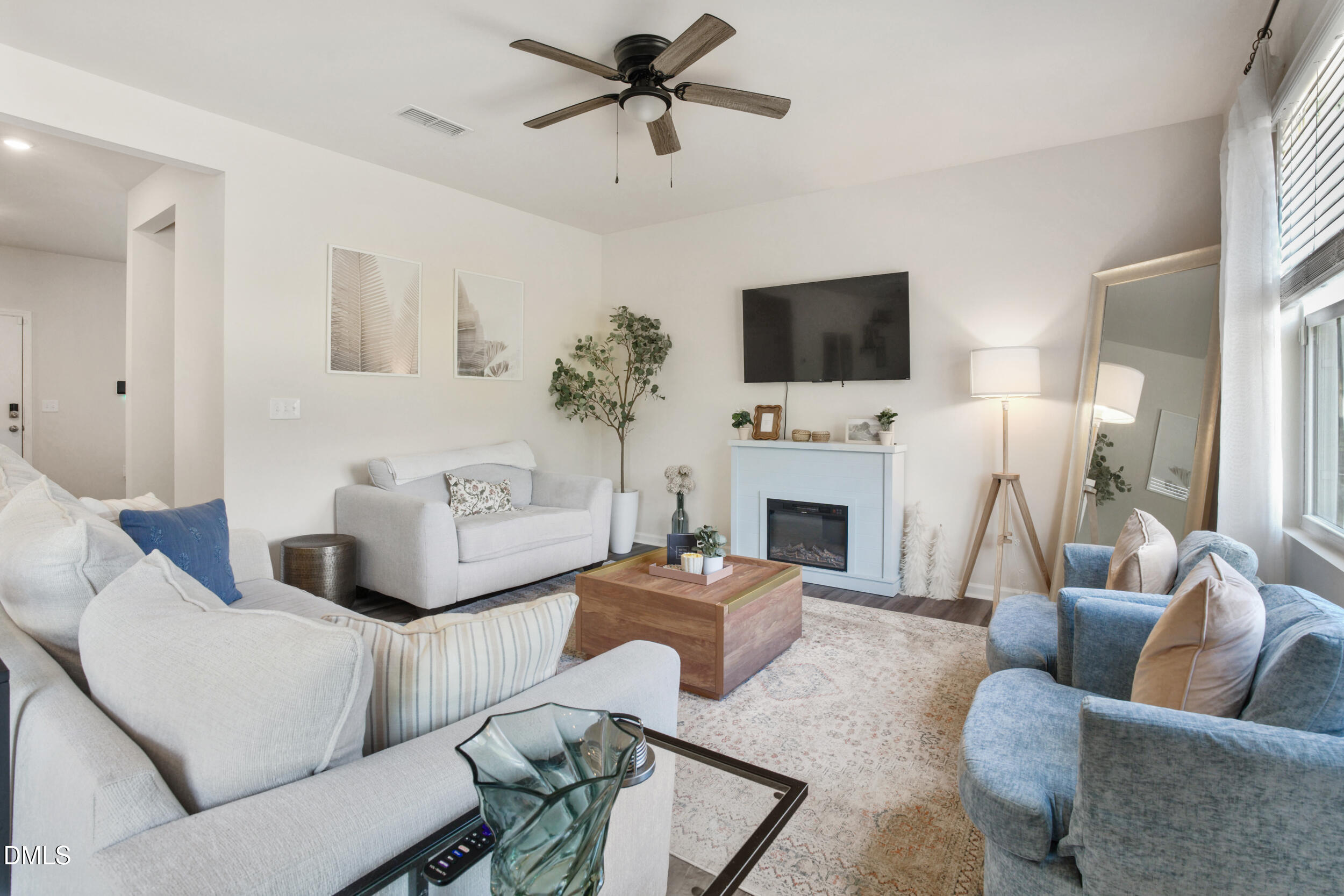 1416 Heron Pond Street Raleigh, NC 27604 - Photo 12 of 25 a living room with furniture a fireplace and a flat screen tv