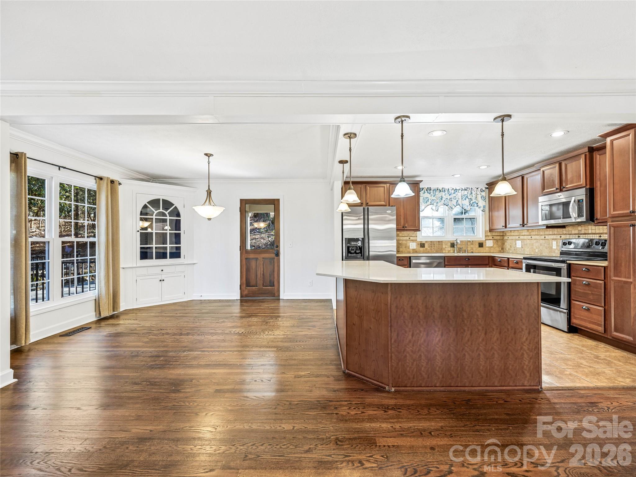 2388 Hebron Road Hendersonville, NC 28739 - Photo 13 of 42 a living room with stainless steel appliances kitchen island granite countertop a large kitchen counter top a stove and a sink with granite countertops