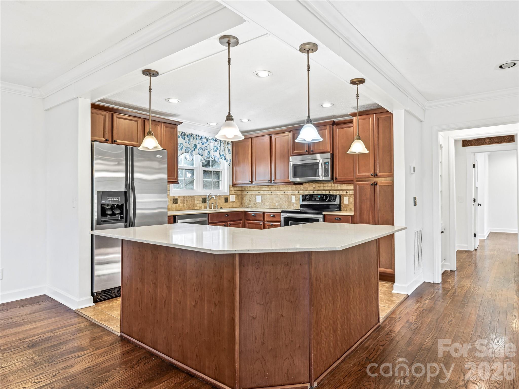 2388 Hebron Road Hendersonville, NC 28739 - Photo 14 of 42 a kitchen with stainless steel appliances granite countertop a sink a stove and a wooden floors