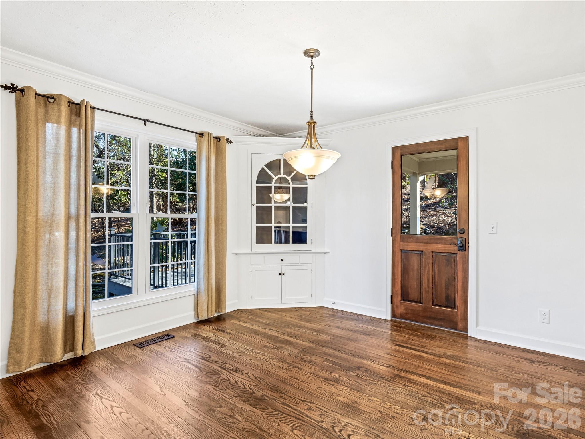 2388 Hebron Road Hendersonville, NC 28739 - Photo 15 of 42 a view of an empty room with window and wooden floor