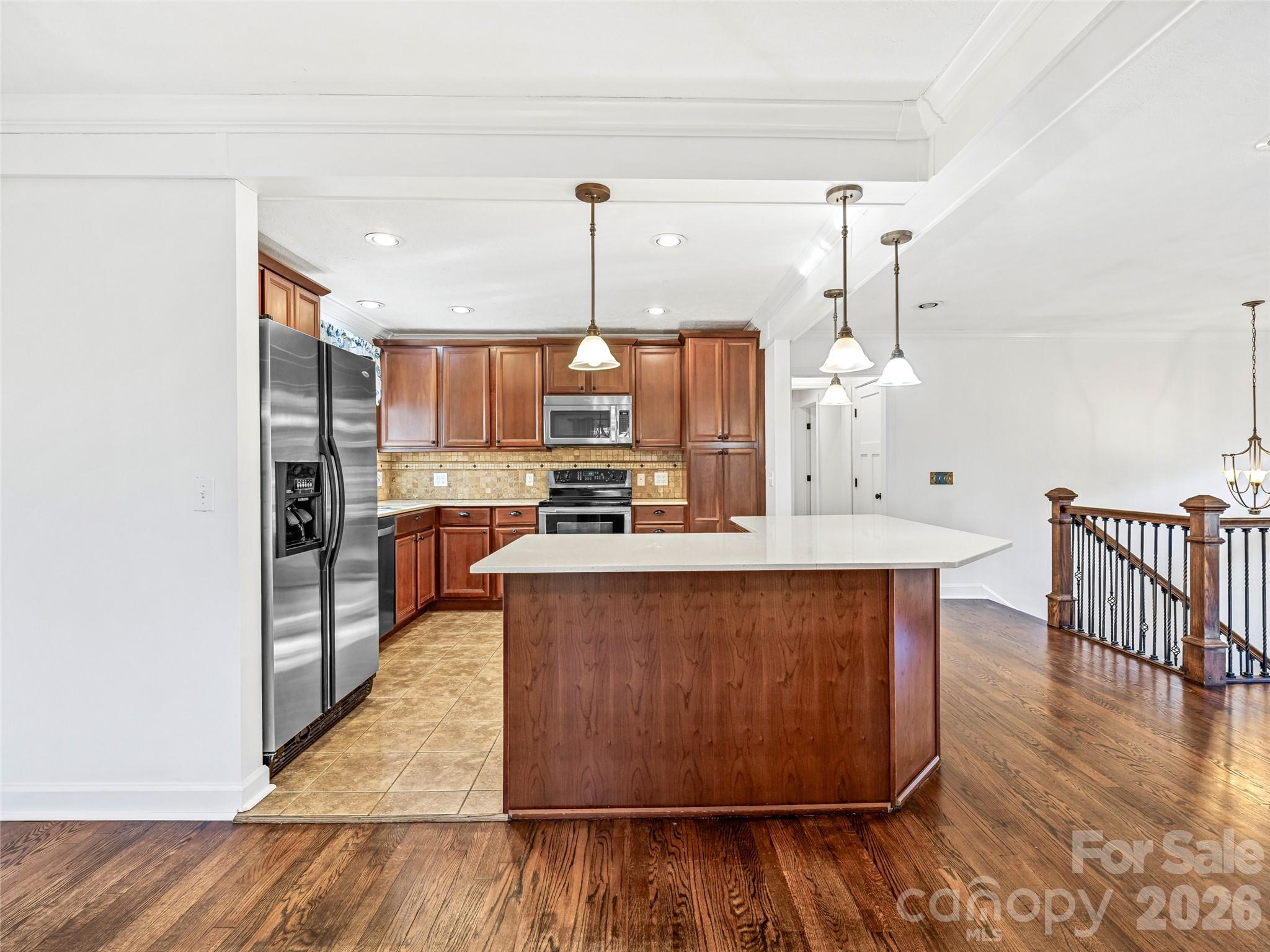 2388 Hebron Road Hendersonville, NC 28739 - Photo 17 of 42 a large kitchen with stainless steel appliances wooden floors and wooden cabinets