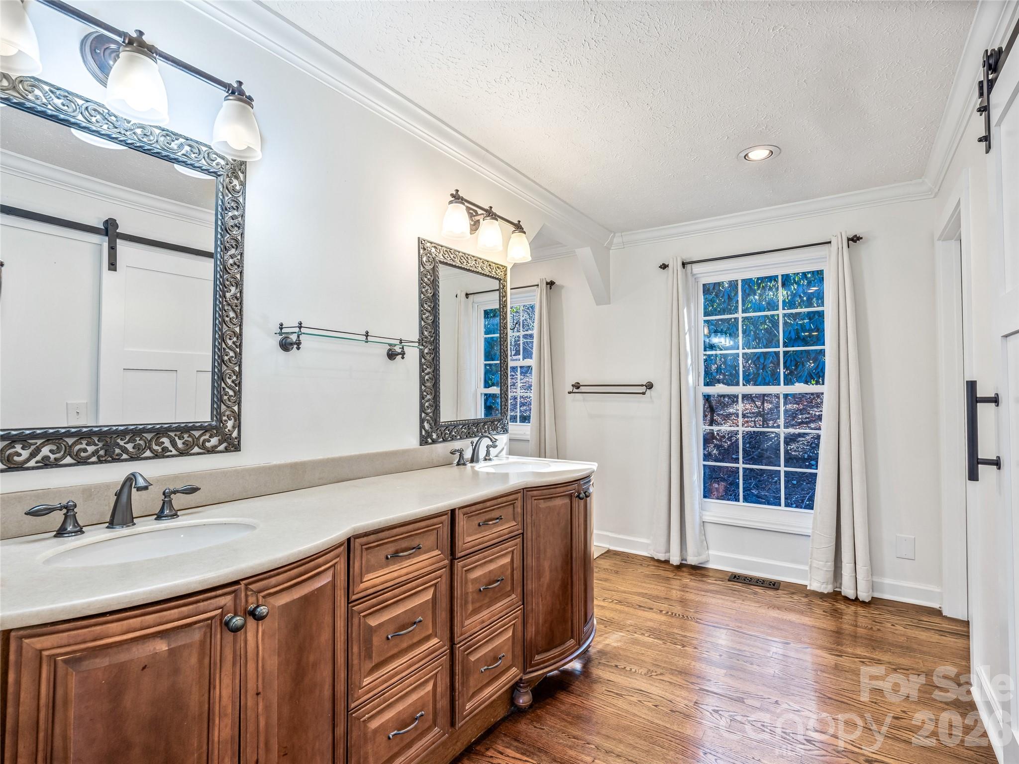 2388 Hebron Road Hendersonville, NC 28739 - Photo 27 of 42 a bathroom with a granite countertop double vanity sink a mirror and a
