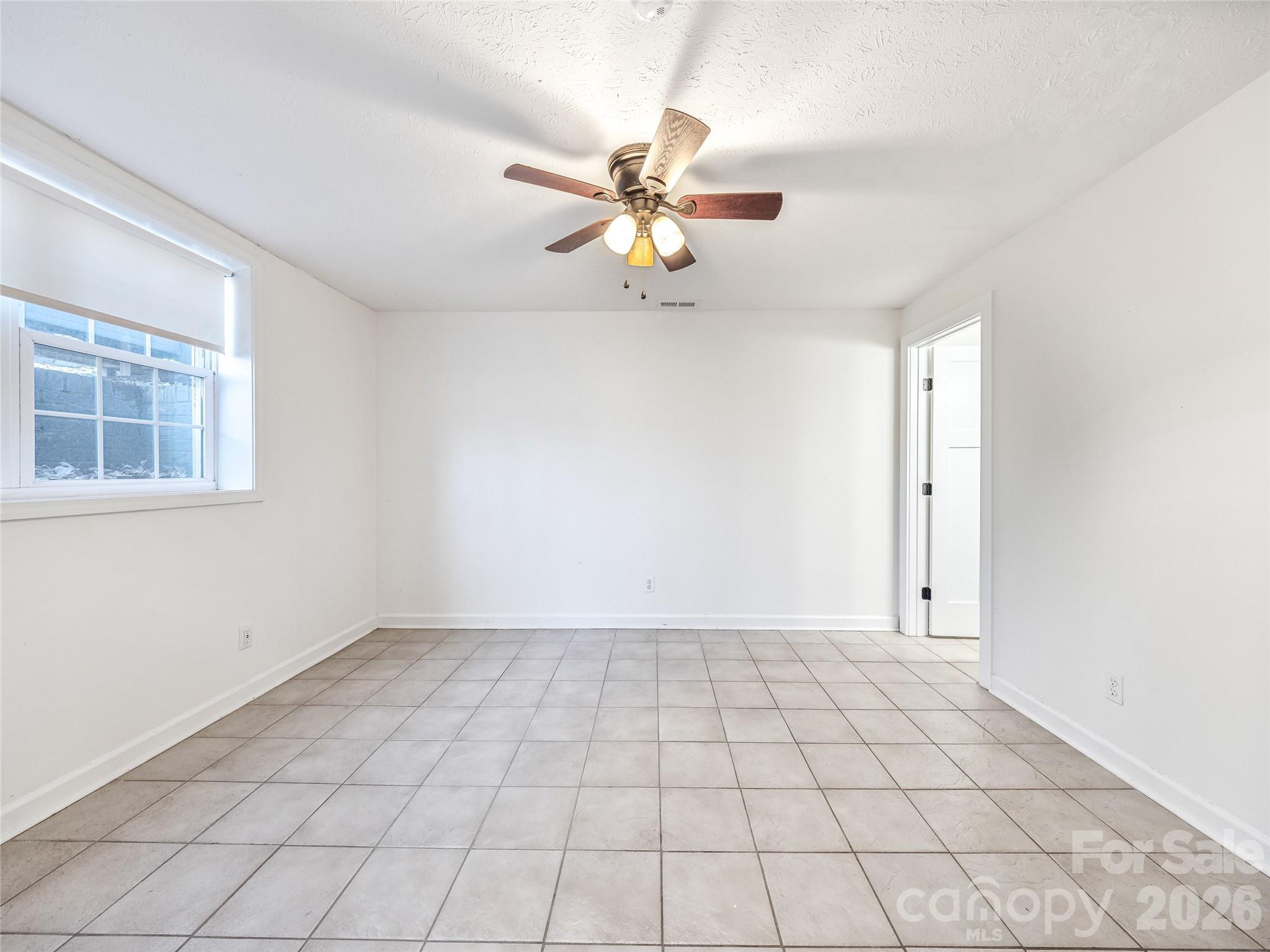 2388 Hebron Road Hendersonville, NC 28739 - Photo 36 of 42 a view of an empty room with chandelier fan and table