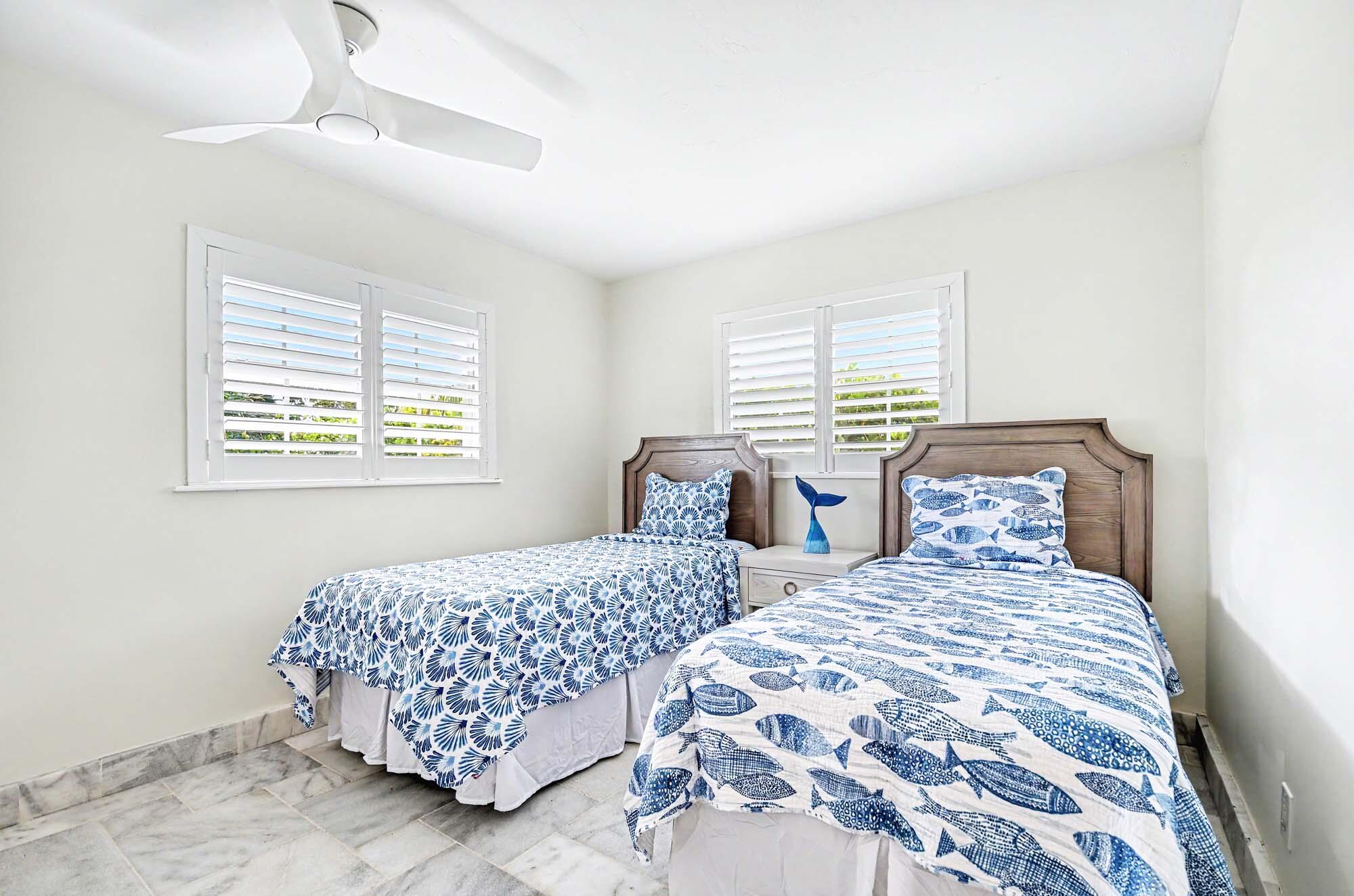 112 Capri Boulevard Naples, FL 34113 - Photo 16 of 29 a bedroom with double bed and a window