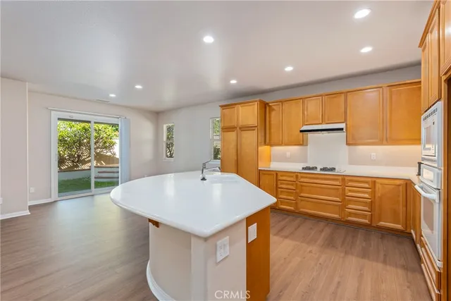 a kitchen with stainless steel appliances granite countertop a sink stove and wooden floor