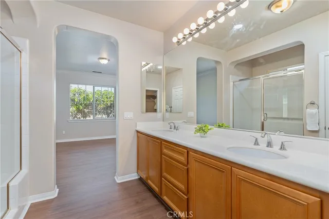 a bathroom with a double vanity sink and a mirror