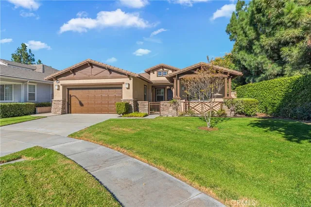 a front view of a house with a garden and plants
