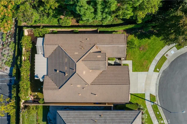 an aerial view of a house with a yard basket ball court and outdoor seating