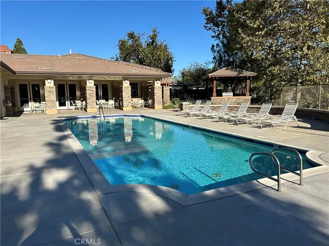 a front view of house with yard patio and swimming pool