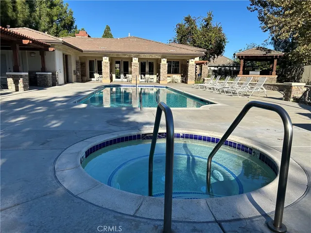 a view of a house with pool yard and sitting area