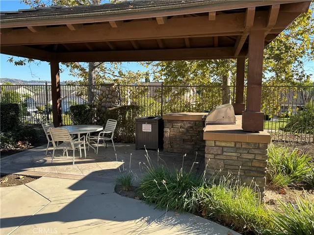 a view of a patio with chairs and potted plants