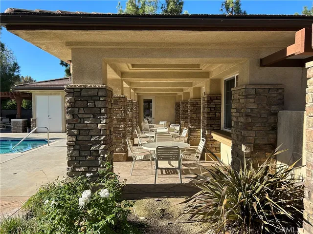 a view of a patio with table and chairs and potted plants