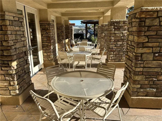 a outdoor patio with chairs