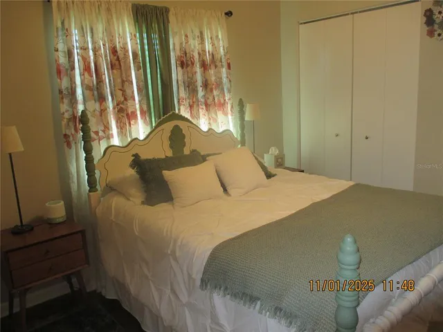 a bedroom with a bed and a window