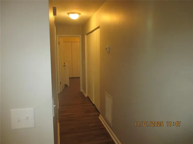 a view of a hallway with wooden floor