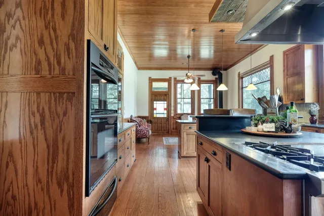 a very nice looking room with wooden floor and furniture