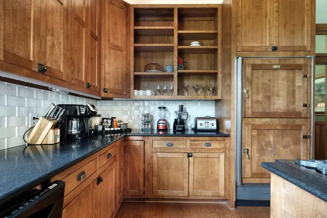 a kitchen with stainless steel appliances granite countertop a refrigerator and stove
