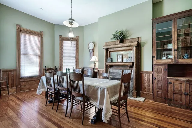 a view of a a dining room with furniture window and wooden floor