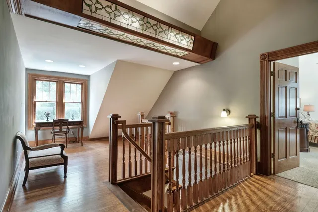 a view of a hallway with dining room and stairs