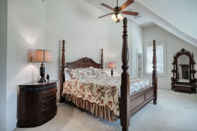 a bedroom with a bed and a chandelier