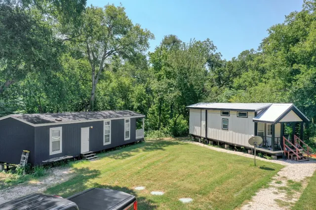 a view of house with backyard and garden