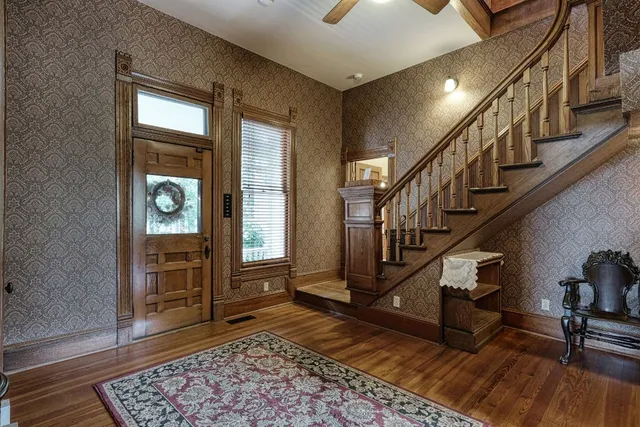a view of entryway with wooden floor and stairs