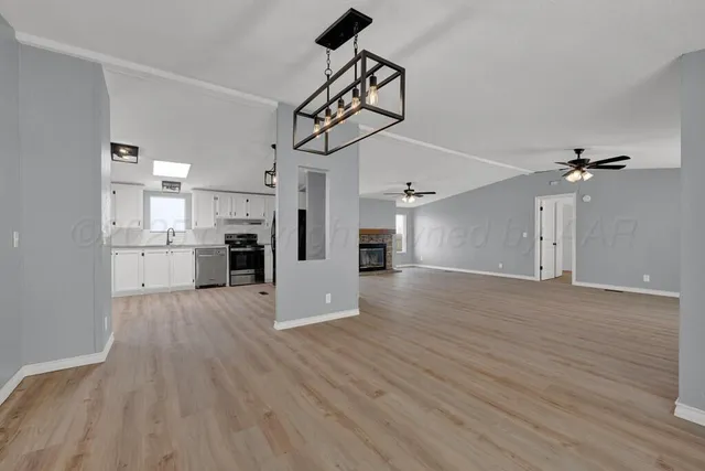 a view of a kitchen with a sink and a refrigerator