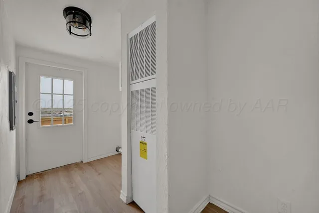 a view of an empty room with window and fireplace