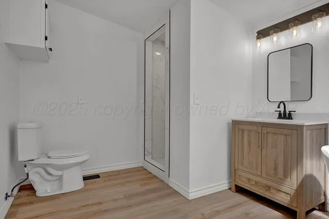 a view of a bathroom with a hardwood floor