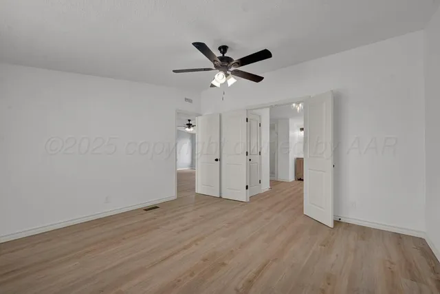 a kitchen with white cabinets and appliances