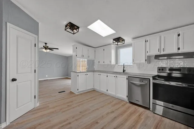 a kitchen with a refrigerator and a sink