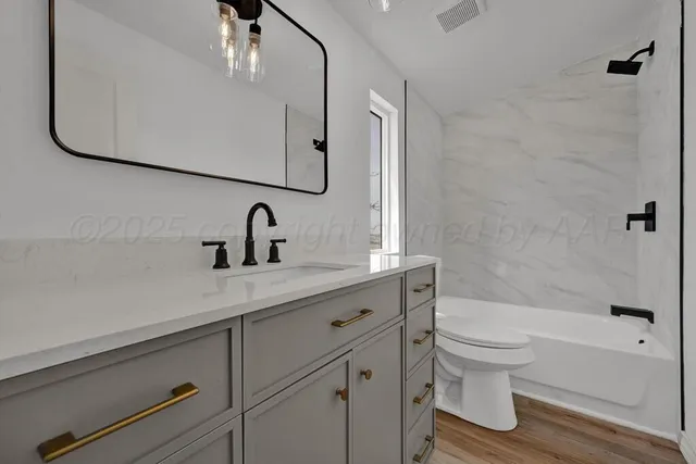 a bathroom with a sink a toilet and a bathtub