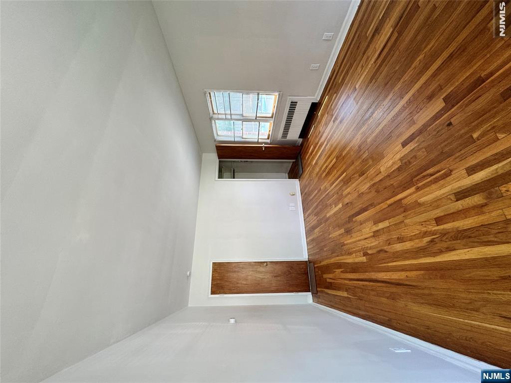 251 Fort Lee Road, Unit D Teaneck, NJ 07666 - Photo 3 of 14 a view of empty room with window and wooden floor