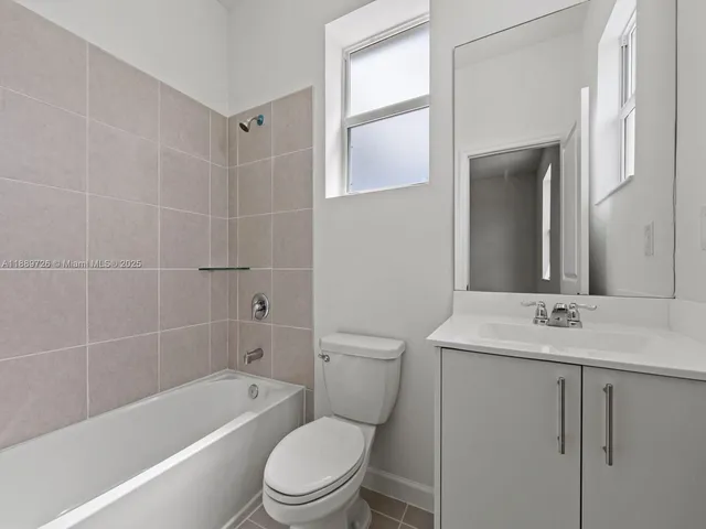 a bathroom with a toilet a sink and bathtub