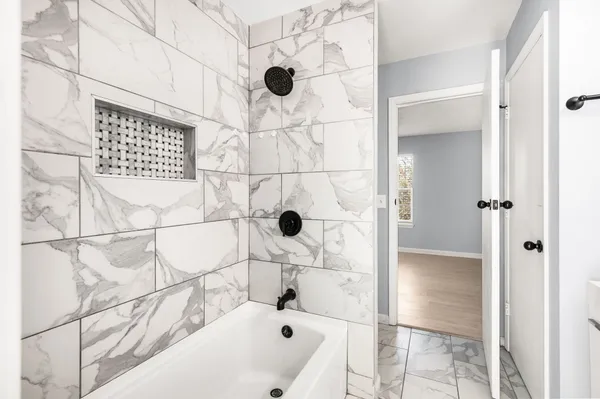 a bathroom with a bathtub and shower