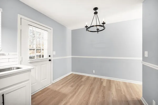 a view of a kitchen with a white wooden cabinets