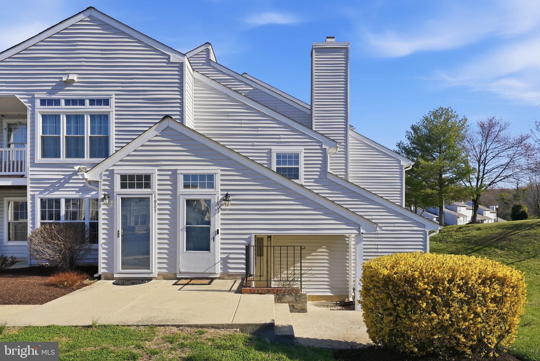 1003 Spring Valley Court Fort Washington, MD 20744 - Photo 1 of 25 a front view of a house with a yard